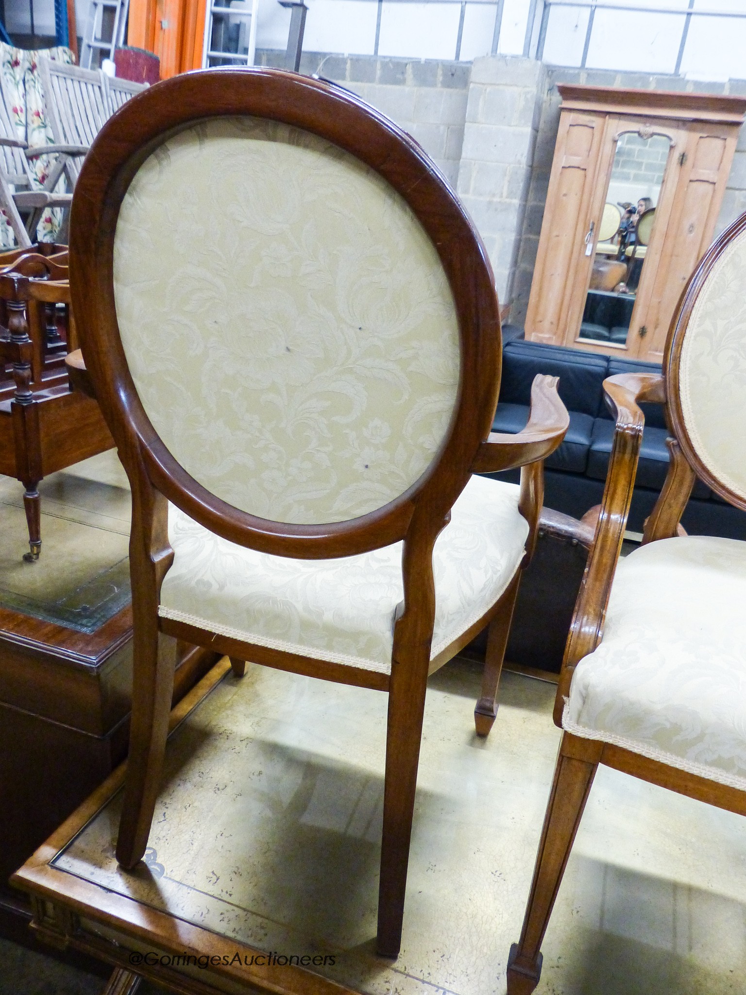 A pair of upholstered elbow chairs, width 57cm, height 100cm